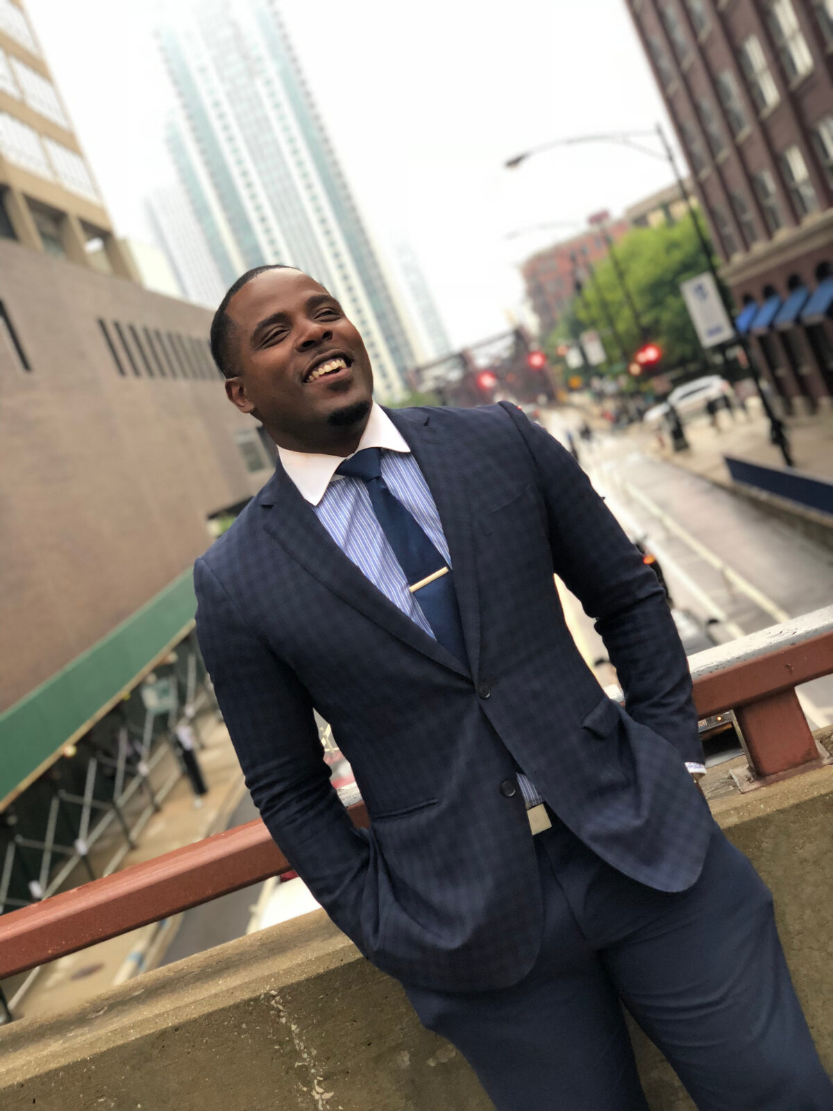 Isiah Williams on a bridge with the Chicago skyline behind him
